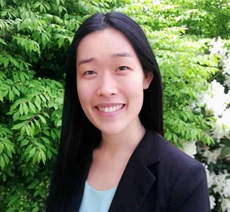 Portrait of Tracy in front of a green foliage